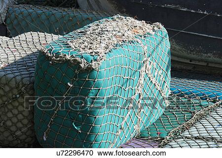 Floating buoys wrapped with commercial fishing nets View Large Photo Image Stock Image - Floating buoys wrapped with commercial fishing nets. Fotosearch