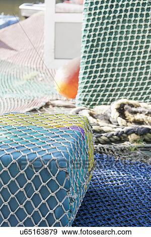 Floating buoys wrapped with commercial fishing nets View Large Photo Image Stock Photo - Floating buoys wrapped with commercial fishing nets. Fotosearch