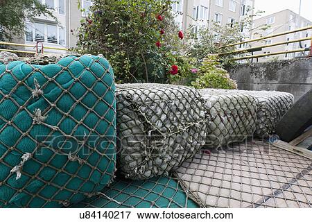 Stock Photo - Floating buoys wrapped with commercial fishing nets. Fotosearch