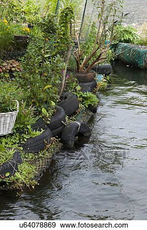 Stock Photo - Floating cottage with flower garden. Fotosearch