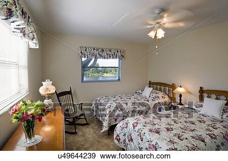 Floral print bedding on beds in traditional bedroom View Large Photo Image Stock Photo - Floral print bedding on beds in traditional bedroom. Fotosearch