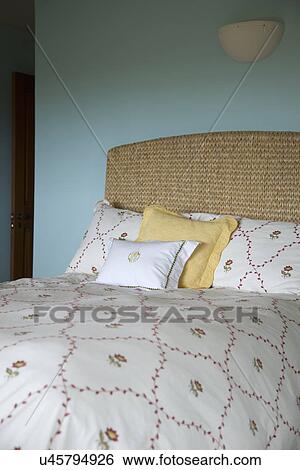 Stock Photograph - Floral print comforter on bed; Carpinteria; California; USA. Fotosearch