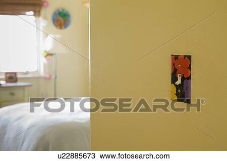 Stock Image - Flower painted decorative light switch outside bedroom; Carpinteria; California; USA. Fotosearch