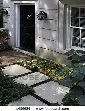 FRONT DOORS: City living, cut limestone, black door, brick walk, stepping stones, begonia and hydrangea View Large Photo Image Stock Image - FRONT DOORS: City living, cut limestone, black door, brick walk, stepping stones, begonia and hydrangea. Fotosearch