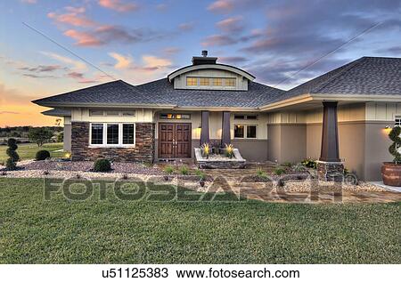 Stock Image - Front elevation custom home with landscaping; Loxahatchee; Florida; USA. Fotosearch