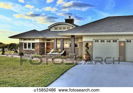 Stock Photograph - Front elevation custom home with landscaping; Loxahatchee; Florida; USA. Fotosearch
