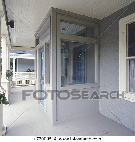 Picture - Front entrance of gray stucco house. Fotosearch