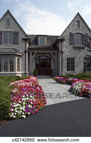 Stock Image - Front exterior of traditional home. Fotosearch