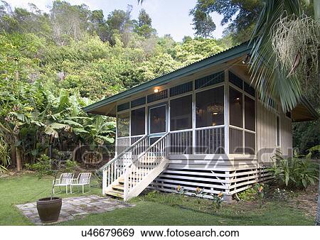 Front exterior of white cottage in tropical environment; Makawao; Hawaii; USA View Large Photo Image Stock Photo - Front exterior of white cottage in tropical environment; Makawao; Hawaii; USA. Fotosearch