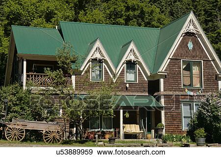 Stock Photo - Front exterior shingle style home; USA; Colorado; Ouray. Fotosearch