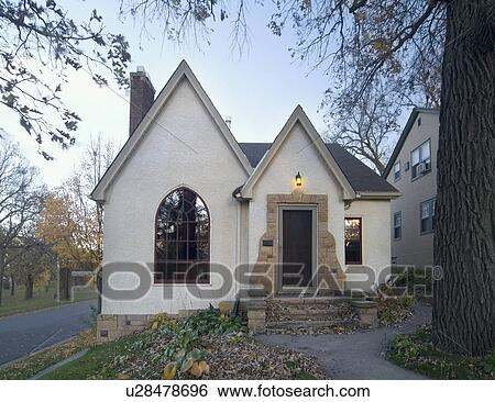 Stock Photograph - Front exterior view of white cottage with stone stairs and pointed rooftops; Minneapolis; Minnesota; MN. Fotosearch