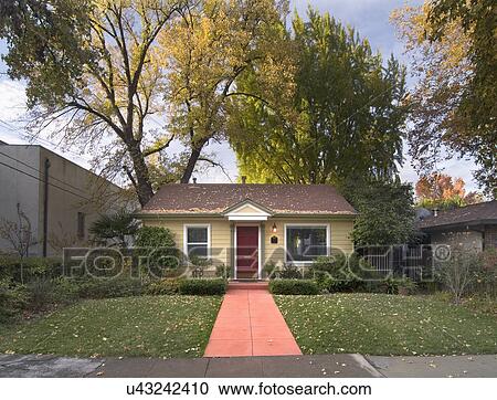 Stock Image - Front exterior yellow cottage; Chico; California; USA. Fotosearch