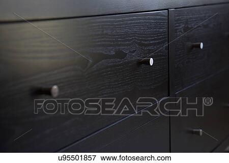 Stock Photo - Front of contemporary dresser with small knobs. Fotosearch