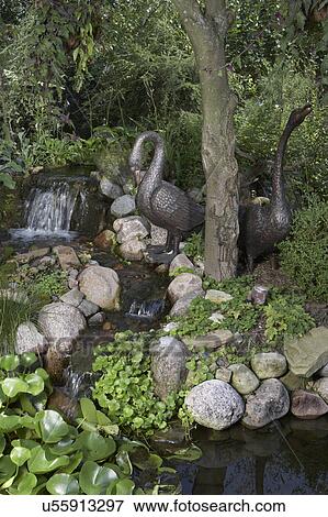 GARDEN: DETAIL: bronze sculpture, waterfall to left, rocks edge to pond View Large Photo Image Stock Photo - GARDEN: DETAIL: bronze sculpture, waterfall to left, rocks edge to pond. Fotosearch