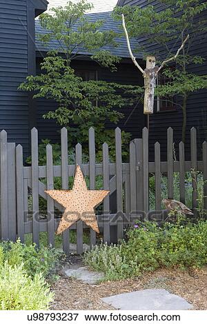 GARDEN: detail, rustic picket fence, metal star on gate, twig scarecrow, View Large Photo Image Stock Photo - GARDEN: detail, rustic picket fence, metal star on gate, twig scarecrow,. Fotosearch