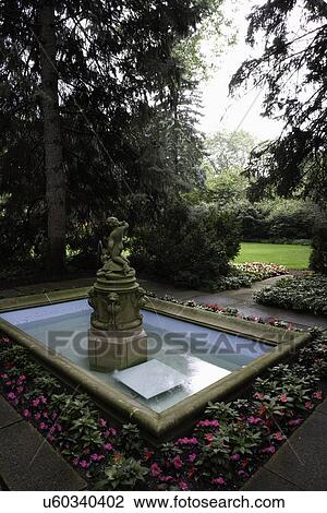 Stock Image - GARDEN: shade garden, rectangular classical pool with cherub fountain. Fotosearch
