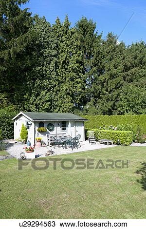 Stock Image - Garden shed in backyard. Fotosearch