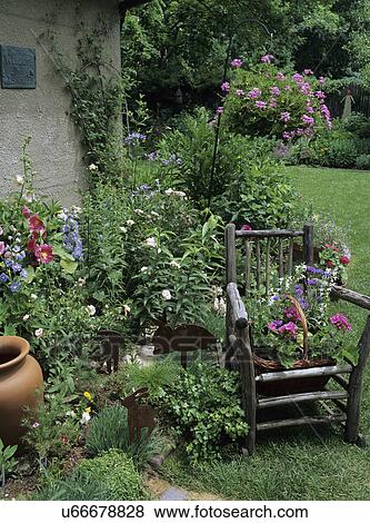 Gardens: Corner of garden. Old chair. Mixed flowers in pot. View Large Photo Image Stock Photo - Gardens: Corner of garden. Old chair. Mixed flowers in pot.. Fotosearch