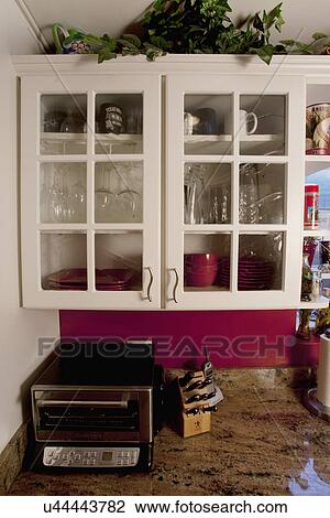 Glass front cabinets in kitchen View Large Photo Image Stock Image - Glass front cabinets in kitchen. Fotosearch
