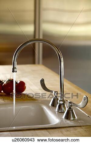 Gooseneck faucet with running water View Large Photo Image Stock Image - Gooseneck faucet with running water. Fotosearch