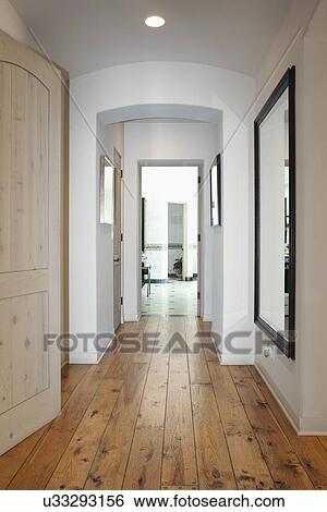 Stock Photograph - Hallway with mirror on wall in home, California, USA. Fotosearch