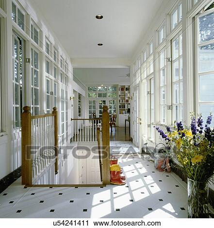 Hallway with windows and gardening equipments by staircase View Large Photo Image Stock Image - Hallway with windows and gardening equipments by staircase. Fotosearch
