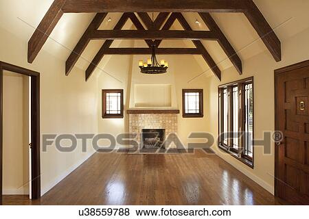 Hardwood Floor In Empty Living Room With Fireplace Mantel