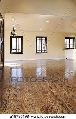 Stock Photo - Harwood floor and chandelier in empty home, Pasadena, California, USA. Fotosearch