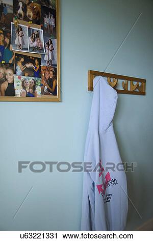Stock Image - Hooded sweatshirt hanging on hook in blue bedroom; Carpinteria; California; USA. Fotosearch