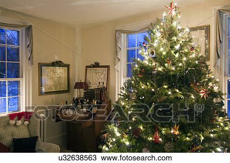 Illuminated Christmas tree in domestic room View Large Photo Image Stock Image - Illuminated Christmas tree in domestic room. Fotosearch