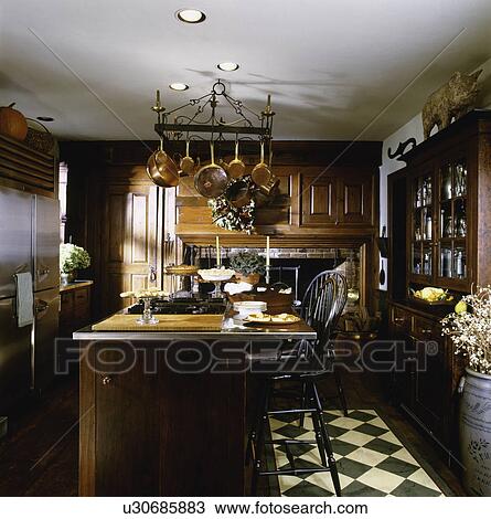 Stock Image - Interior of a contemporary kitchen with arranged cooking island, USA. Fotosearch