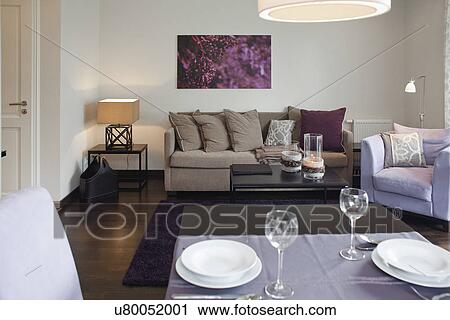 Stock Image - Interior of a contemporary living room with dining area. Fotosearch