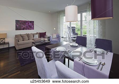 Stock Photo - Interior of a contemporary living room with purple painting on wall. Fotosearch