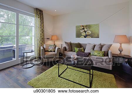 Interior of contemporary living room with coffee table on area rug View Large Photo Image Stock Photography - Interior of contemporary living room with coffee table on area rug. Fotosearch
