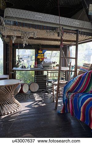 Interior of cottage consisting of typewriter on table with mattress above View Large Photo Image Stock Photo - Interior of cottage consisting of typewriter on table with mattress above. Fotosearch