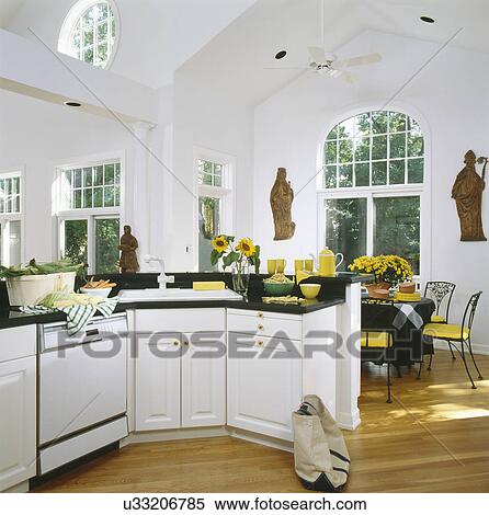 Stock Photography - Interior of kitchen with yellow and white accents. Fotosearch