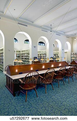 Interior of library with lamps and chairs at study desk in library View Large Photo Image Stock Photo - Interior of library with lamps and chairs at study desk in library. Fotosearch