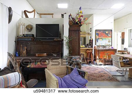 Interior of messy room with flat screen television View Large Photo Image Stock Photo - Interior of messy room with flat screen television. Fotosearch