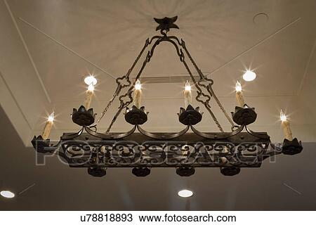 Stock Image - Italian style wrought iron chandelier; Irvine; California; USA. Fotosearch