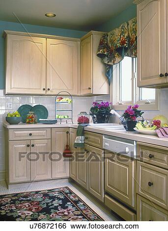 Kitchen Corner With Pink Flowers Rug Window Valance Cabinets