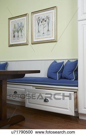 Kitchen Eating Areas: Close up of built in booth against wall, dark blue cushions on cr? me colored wood booth. storage drawers underneath seat, yellow wall View Large Photo Image Stock Image - Kitchen Eating Areas: Close up of built in booth against wall, dark blue cushions on cr? me colored wood booth. storage drawers underneath seat, yellow wall. Fotosearch