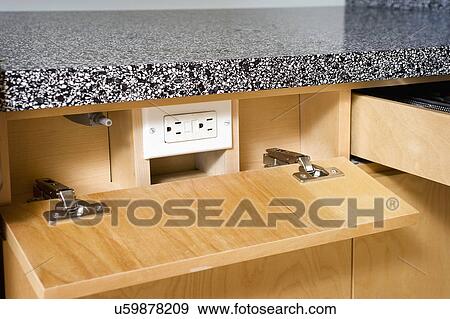 Stock Photo - Kitchen outlet with wooden drop down cover. Fotosearch