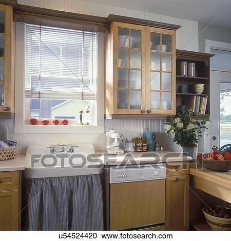 Kitchen Sink Detail Vintage Sink With Striped Cotton Sink Skirt Maple Stained Cabinets With Pebbled Glass Doors Blinds Wainscoting Molding Stock