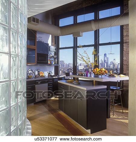 KITCHENS - Loft kitchen, Chicago skyline, old factory building, wood floors, black contemporary cabinets, open duct work, forsythia, View Large Photo Image Stock Photo - KITCHENS - Loft kitchen, Chicago skyline, old factory building, wood floors, black contemporary cabinets, open duct work, forsythia,. Fotosearch