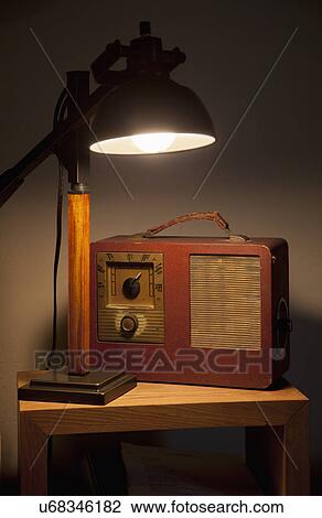 Stock Image - Lamp and old radio on table; Porterville; California; USA. Fotosearch