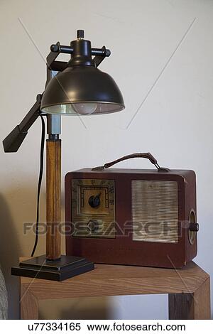 Stock Photography - Lamp and old radio on table; Porterville; California; USA. Fotosearch