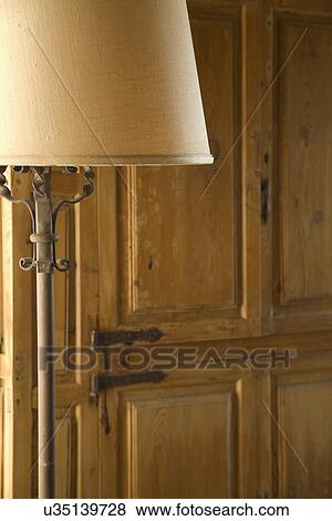 Lampshade in front of wooden cabinet; Carpinteria; California; USA View Large Photo Image Stock Photo - Lampshade in front of wooden cabinet; Carpinteria; California; USA. Fotosearch
