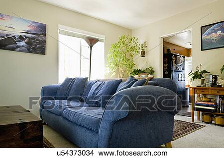 Picture - large blue sofa in living room. Fotosearch