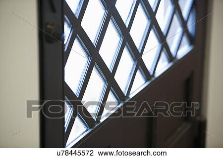 Stock Image - Lattice patterned window on door; Irvine; California; USA. Fotosearch