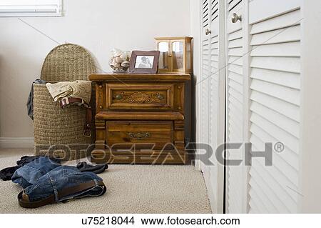 Picture - Laundry basket with scattered clothes in a room, San Diego, California, United States of America. Fotosearch